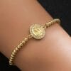 Close-up of graceful Virgin Mary bracelet design
