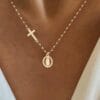 White gold necklace featuring cross and Virgin Mary pendant