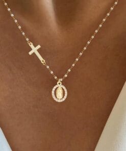 White gold necklace featuring cross and Virgin Mary pendant