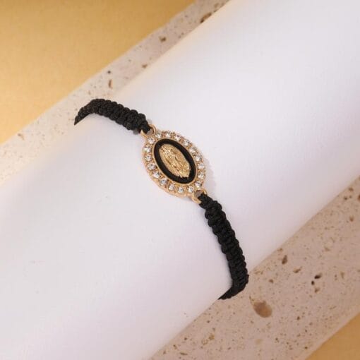 Black bracelet with Mary charm and 18K gold finish — protective and powerful