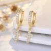 Gold cross drop earrings for faithful women