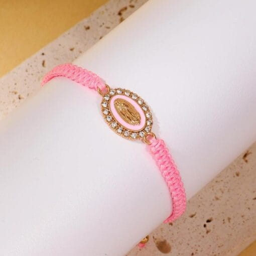 Pink Virgin Mary bracelet with gold finish and holy love